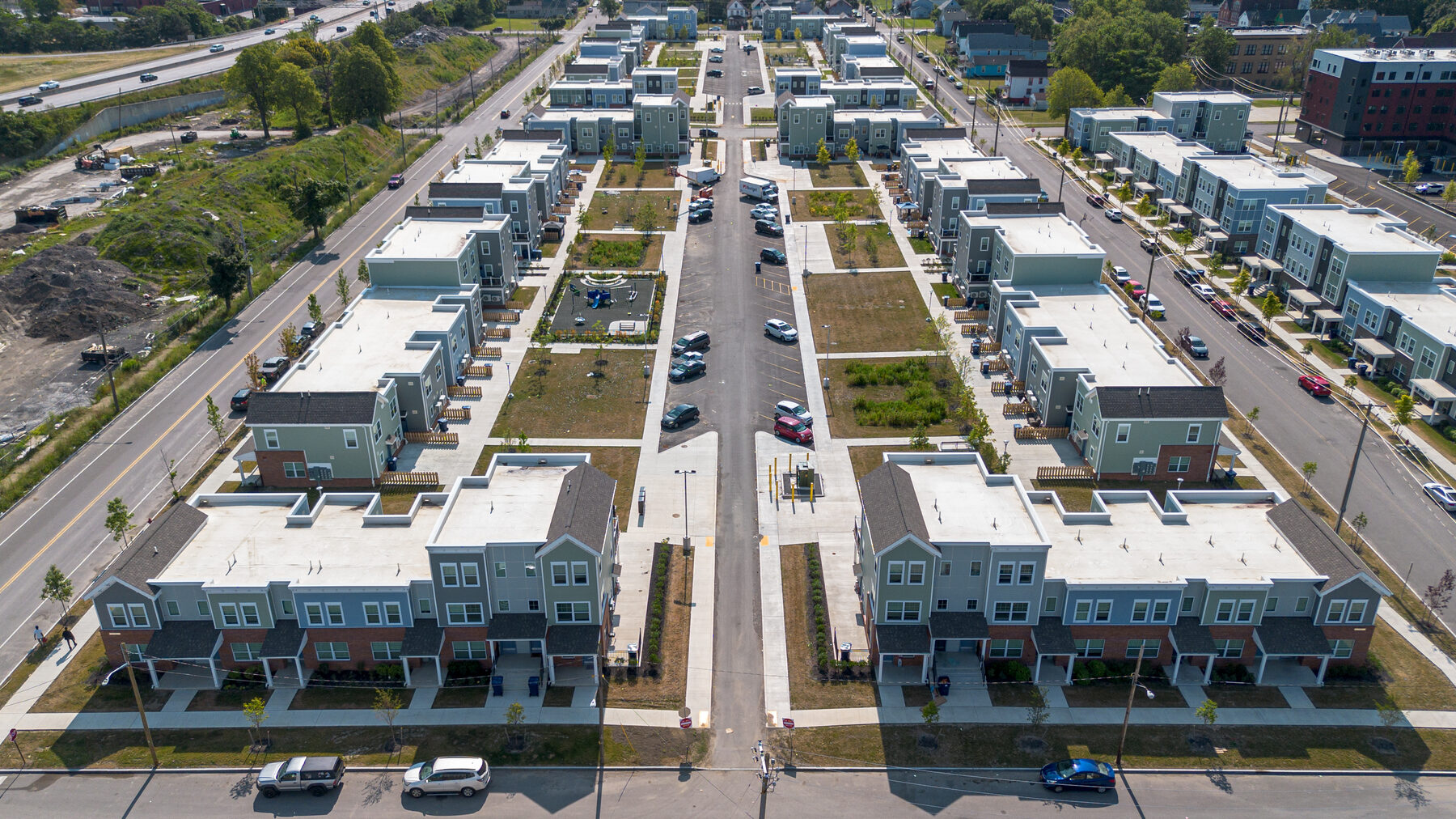 Aerial view of a completed townhome housing development with central green space